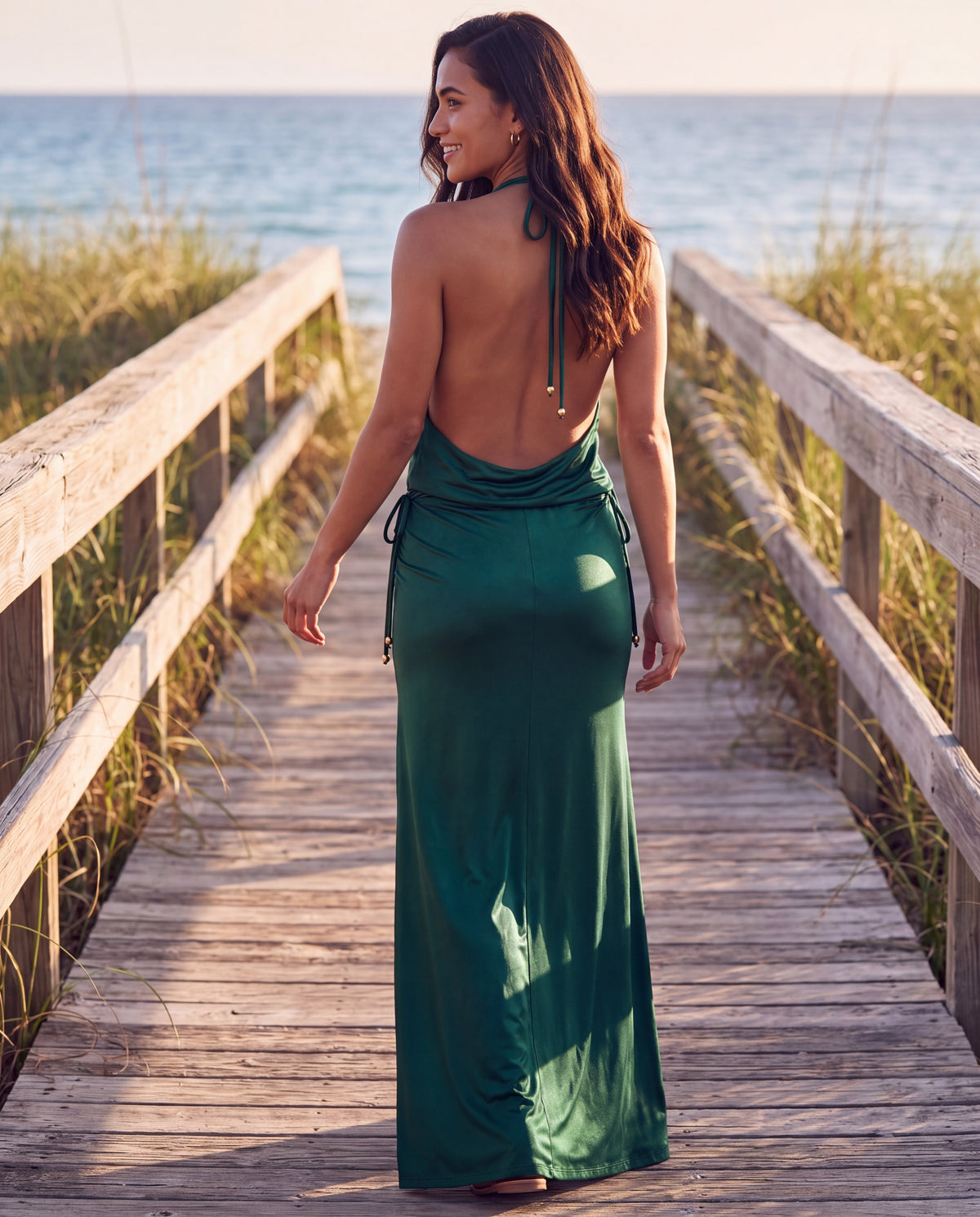 Loren Maxi Dress in Oliva, back view on a beach boardwalk