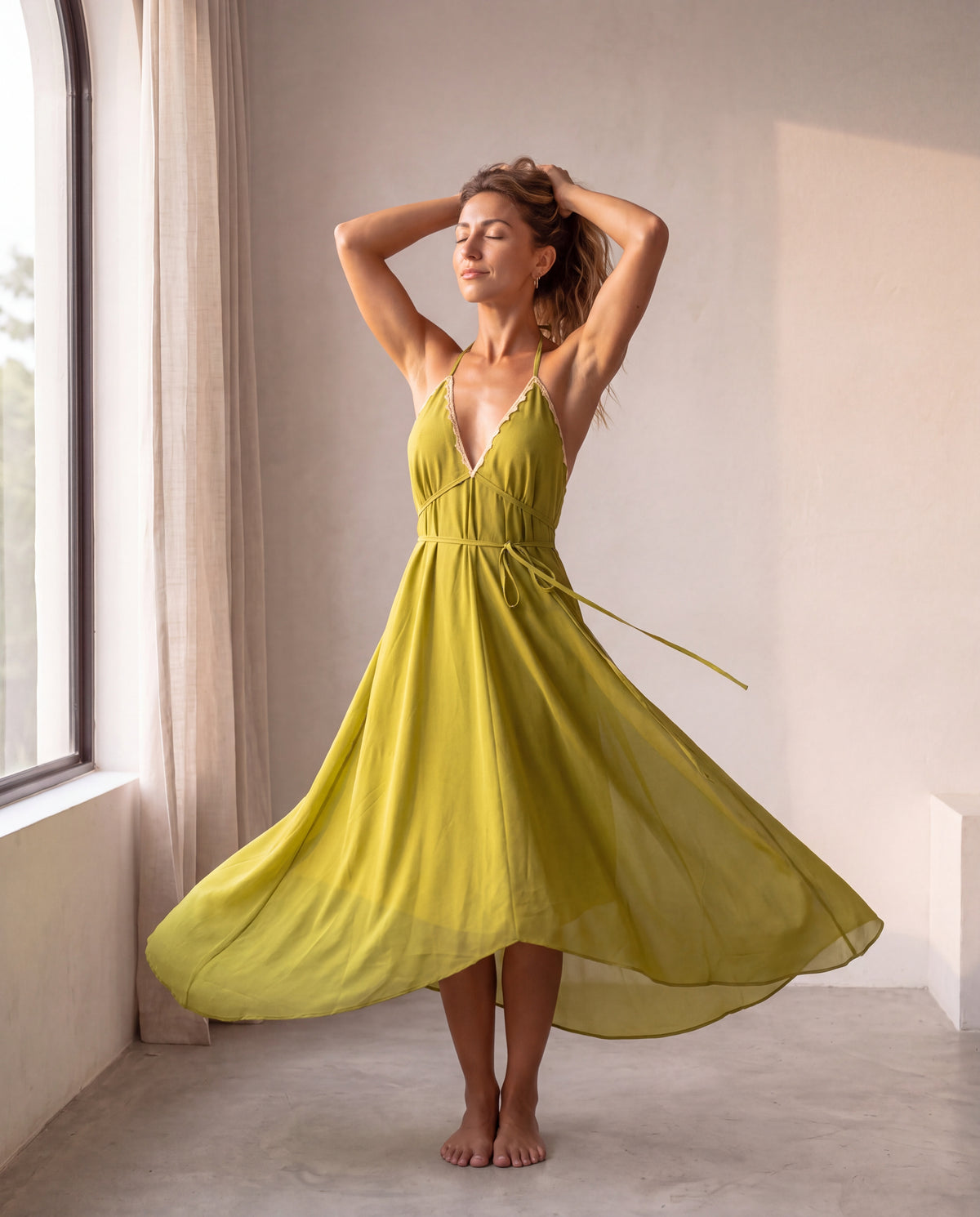 The Amalfi Dress in Oliva - editorial mid-turn pose