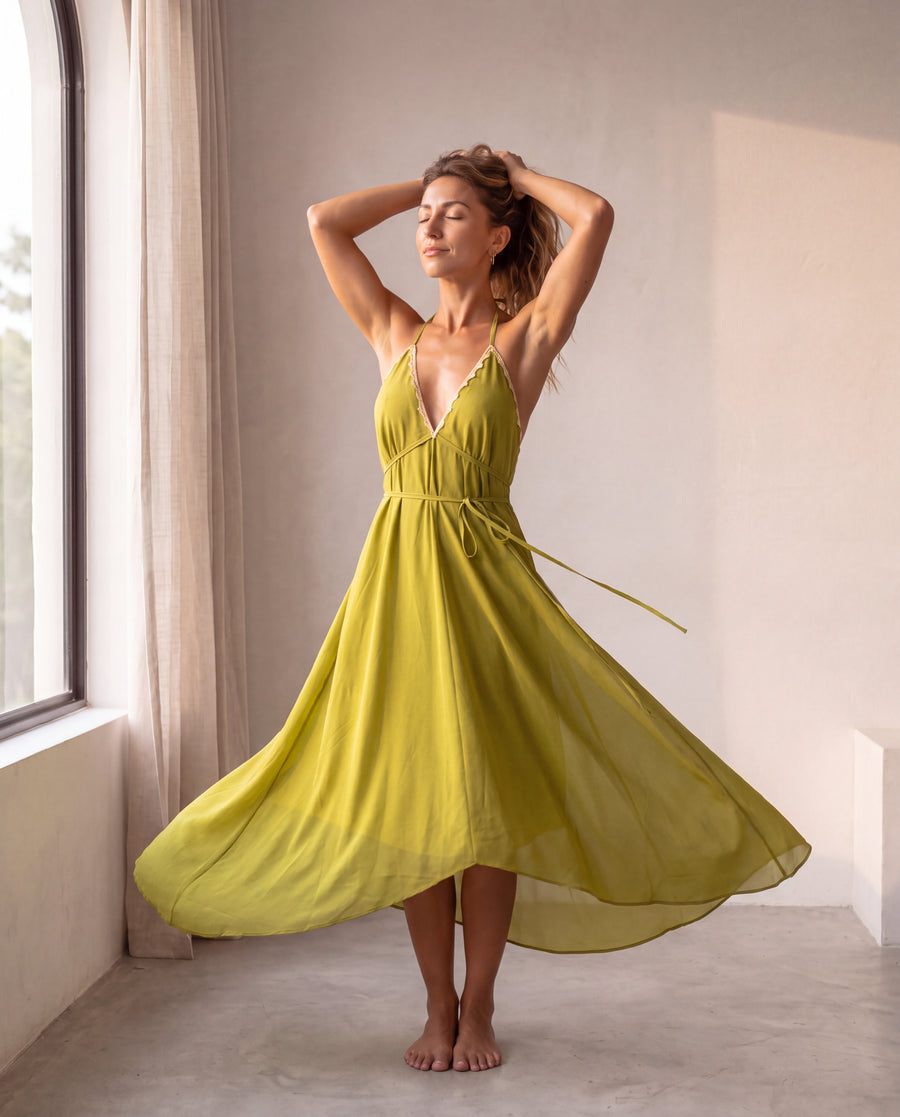 The Amalfi Dress in Oliva - editorial mid-turn pose