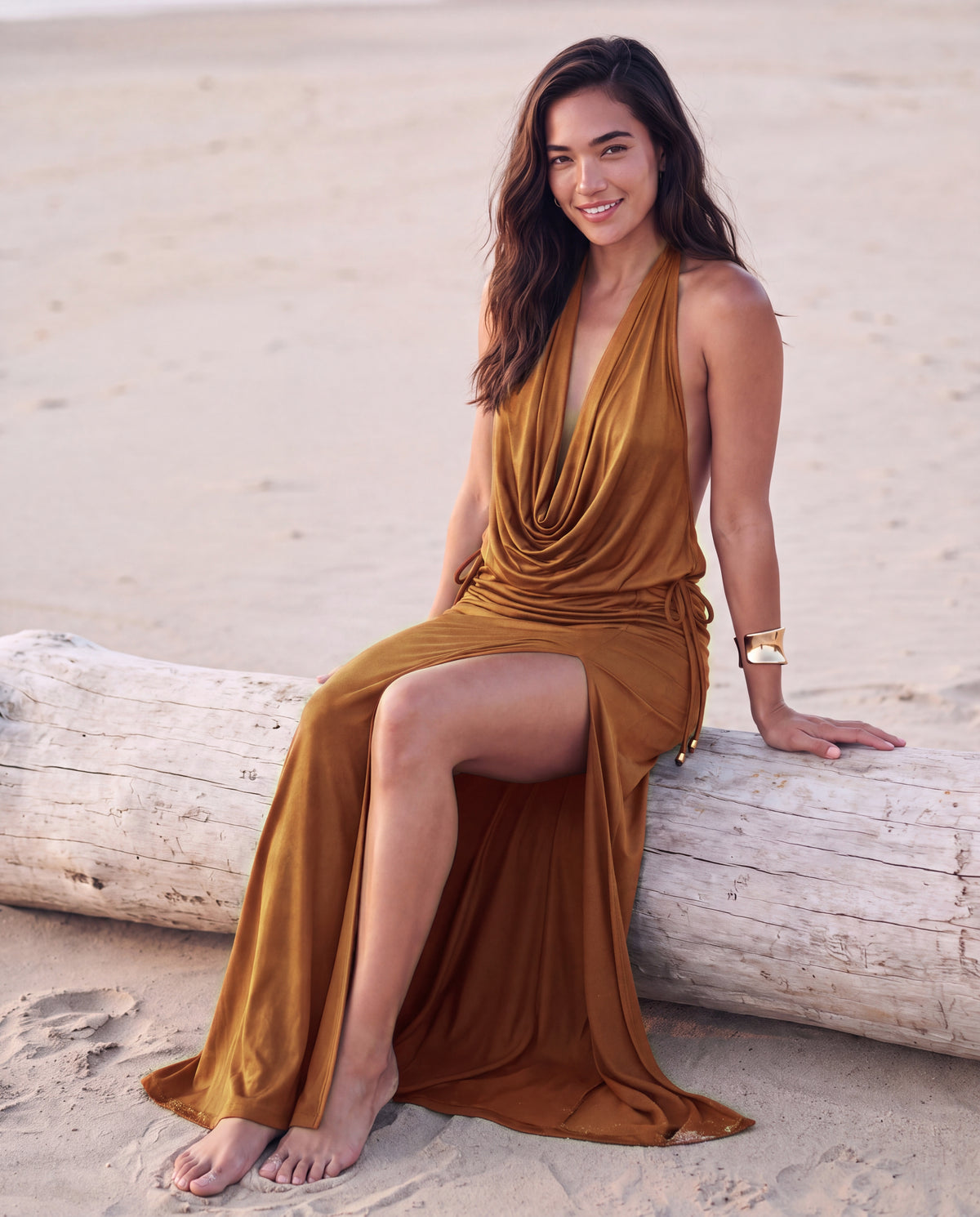 Loren Maxi Dress in Bronze, seated on driftwood