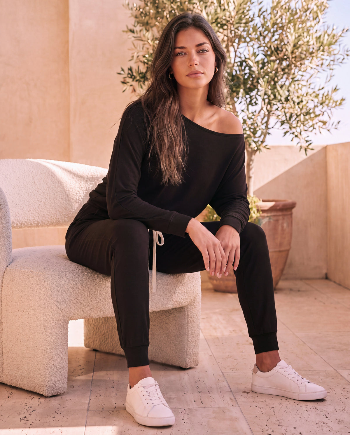 Luxe Lounge Set in Coal, seated on a boucle chair