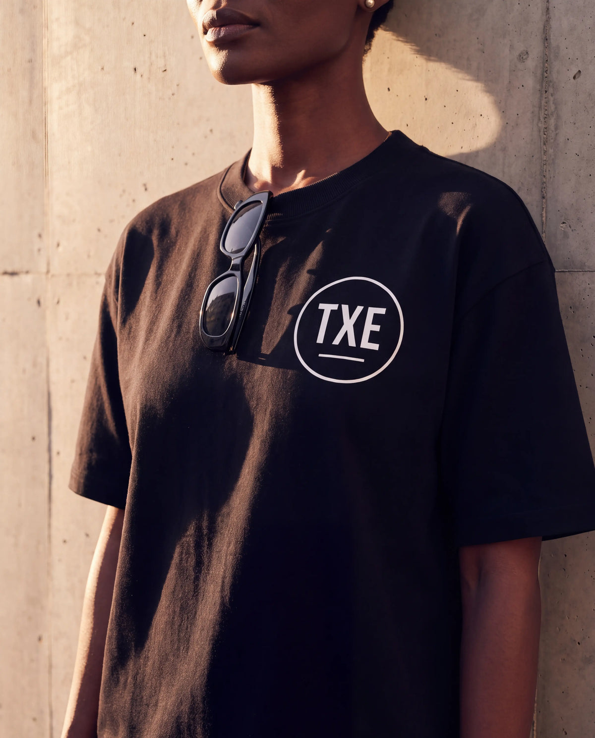 The Signature Tee in Black, TXE roundel detail