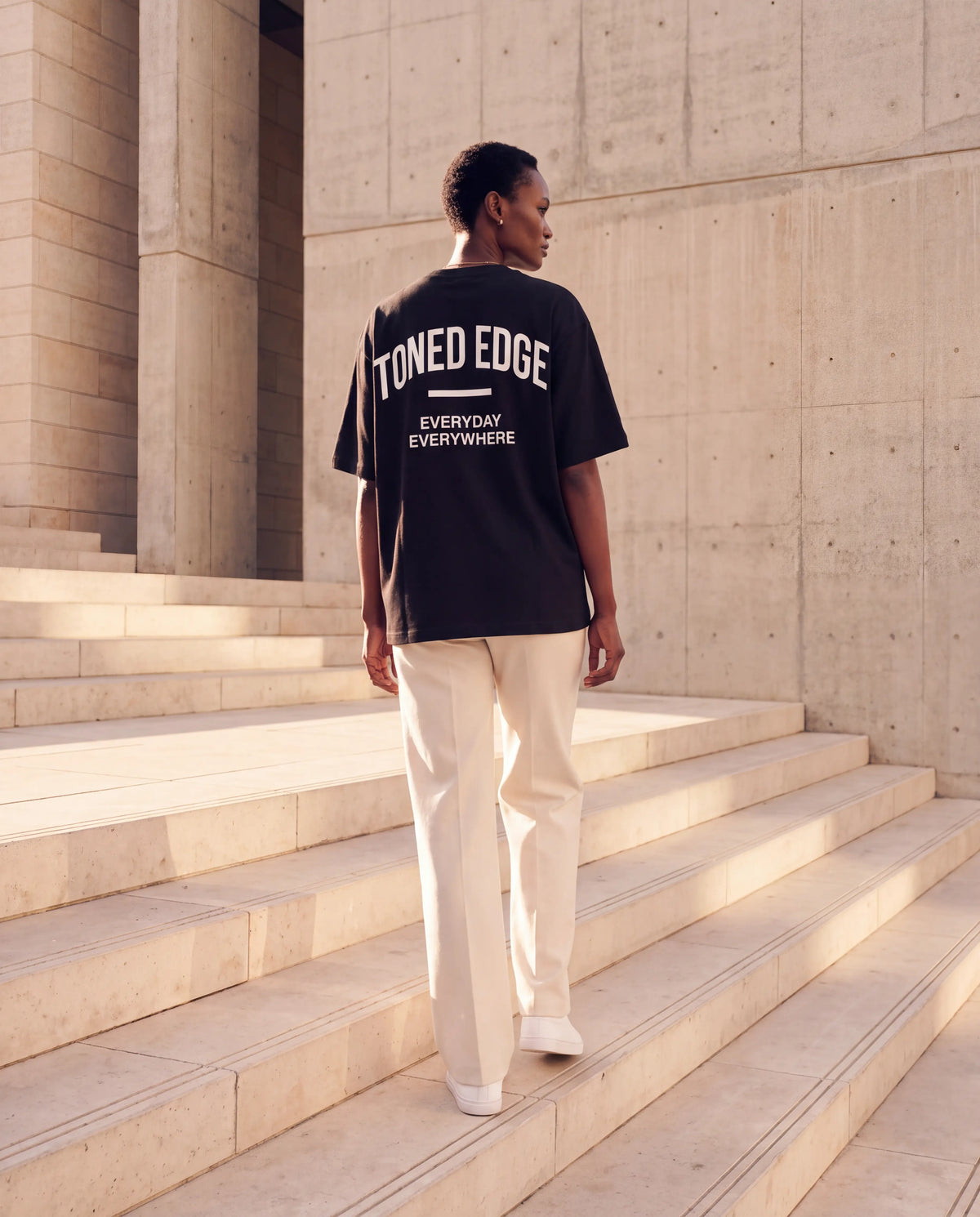 The Signature Tee in Black, back view with arched Toned Edge print