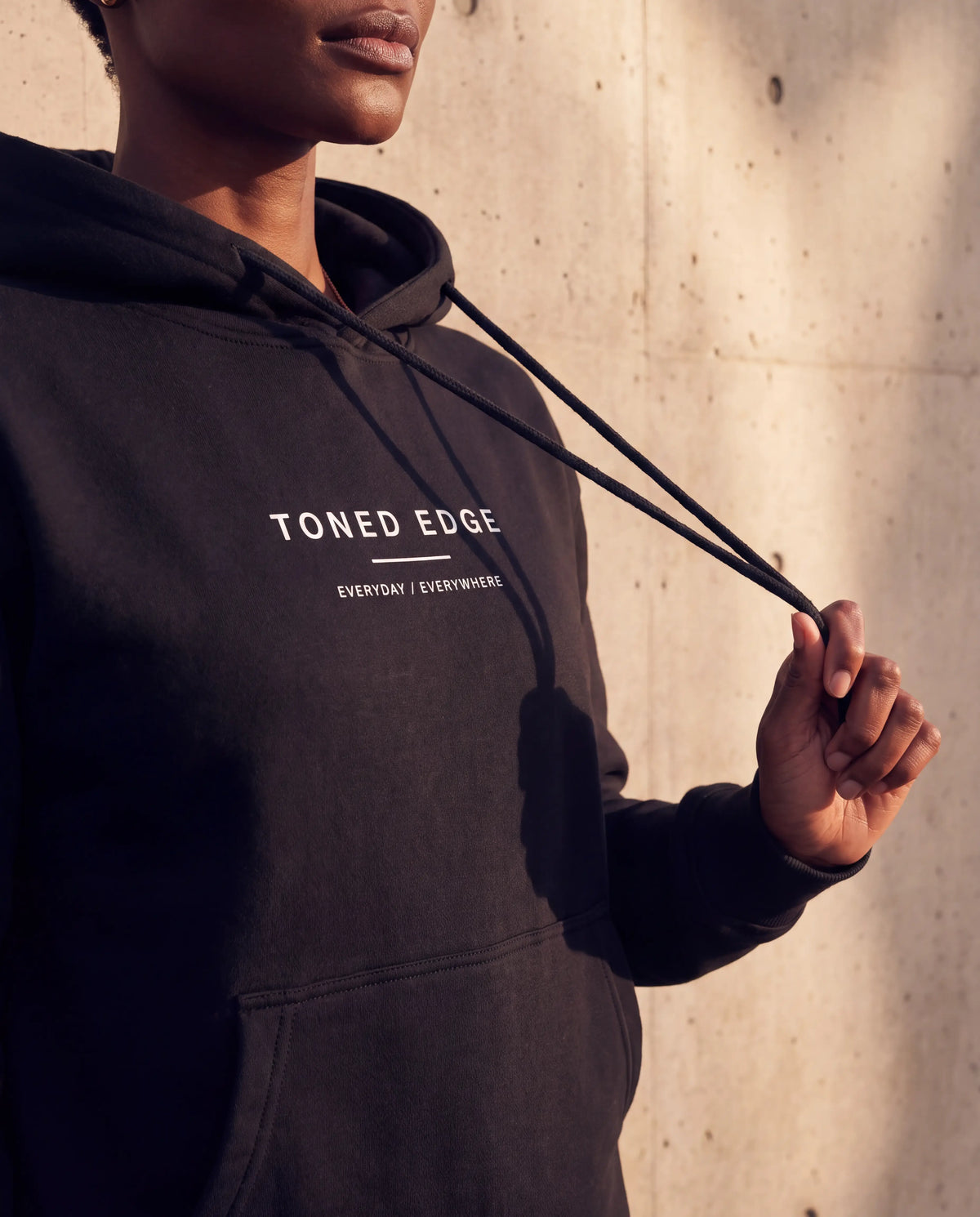 The Everyday Hoodie in Black, chest print detail