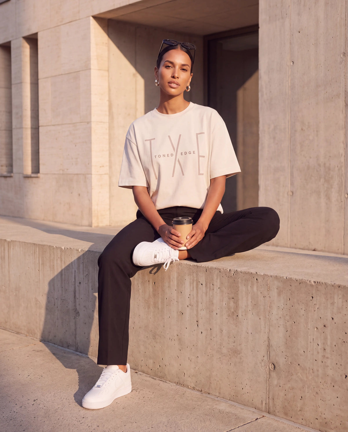 The Tonal Logo Tee in Bone, seated street style