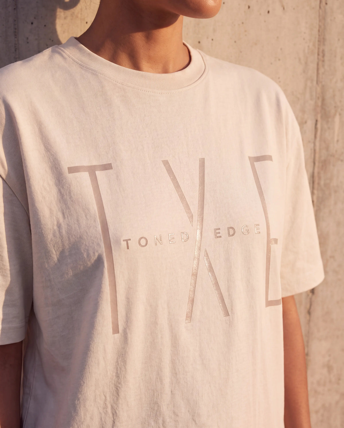 The Tonal Logo Tee in Bone, tonal TXE print detail
